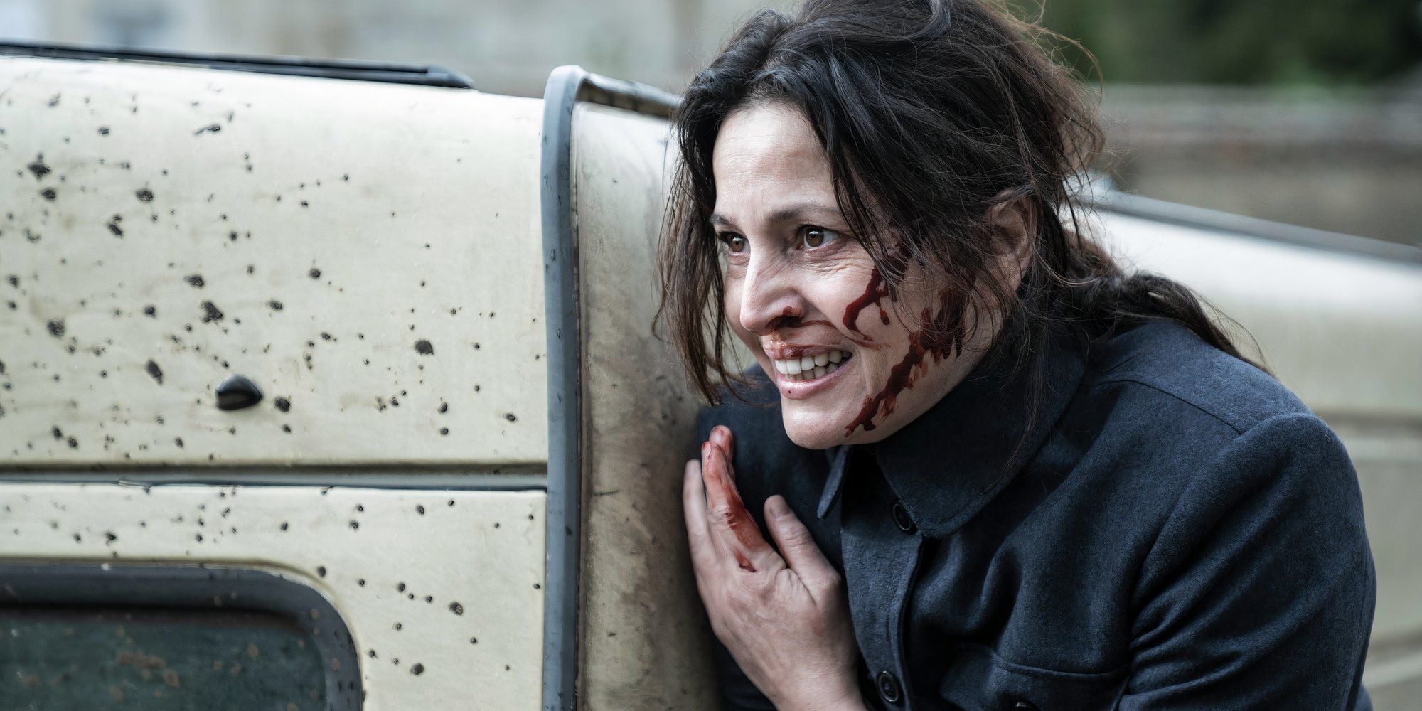 Anne Charrier dans le rôle de Genet appuyé contre une voiture et saignant dans Walking Dead Daryl Dixon saison 2